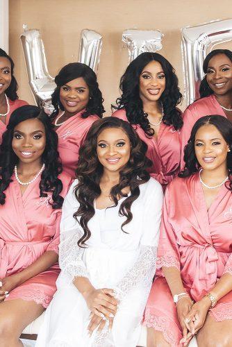 real wedding cindy glen black bride with loose curls and bridesmaids in pink robes before the wedding stanlo photography