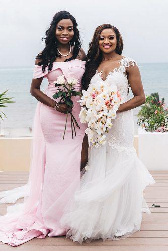 real wedding cindy glen bride in lace dress with cascading bouquet with her bridesmaid in pink dress with white roses stanlo photography