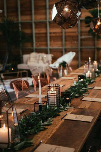 wedding decor 2019 industrial reception with candles and greenery tablerunner cj williams photography