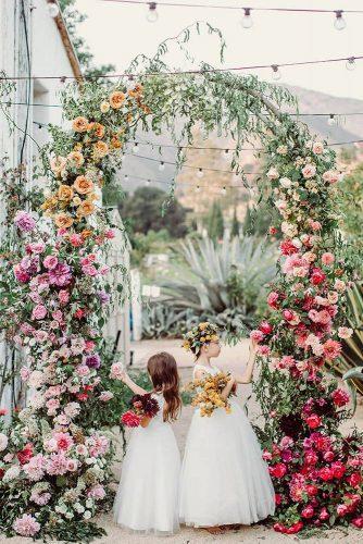 wedding decor 2019 arch with greenery and bright flowers flowergirls jonachristinaphoto