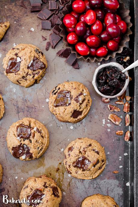 These Cranberry Pecan Chocolate Chip Cookies are gooey in the middle with perfectly crispy edges. Think: your favorite chocolate chip cookie, dressed up with dried cranberries and toasty pecans. I recommend devouring one of these gluten-free, paleo, and vegan cookies warm from the oven.