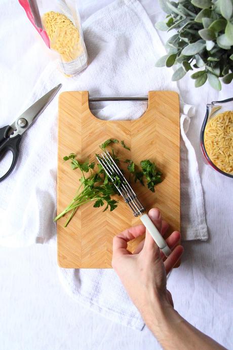 Using herb scissors to cut herbs