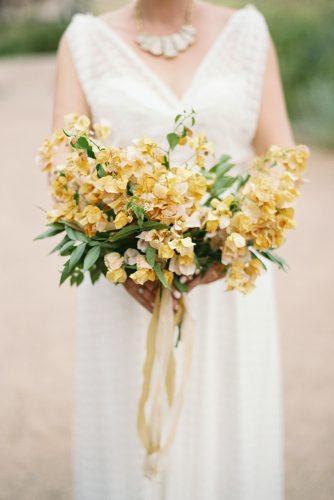mustard wedding bridal bouquetwith greenery airy flowers and ribbons apryl ann photography