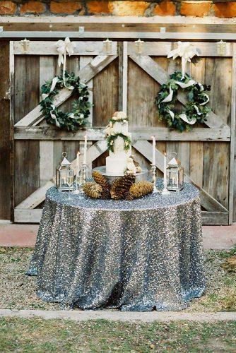 christmas wedding glitter tablecloth for dessert table with white cake candles and lanterns cones decor deisy photography