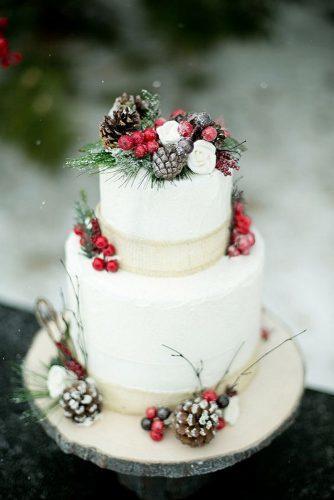 christmas wedding snow white tall cake with red viburnum pine and cones amber lynn photography