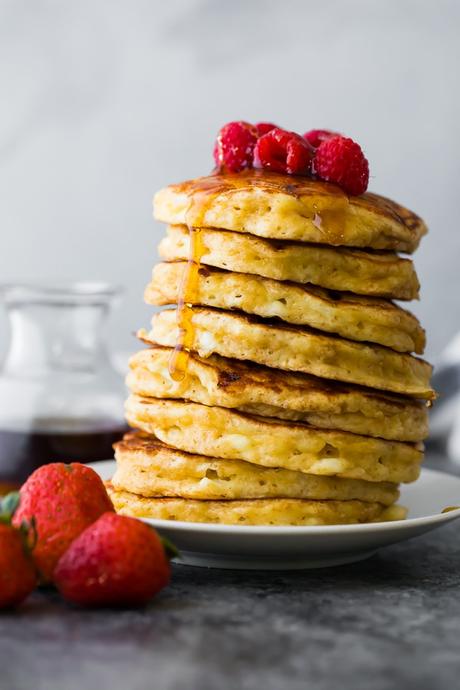 a stack of cottage cheese pancakes with syrup running down the side