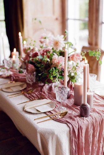 dusty rose wedding flower centerpiece and candles with tloth tablerunner nicoll wedding photography
