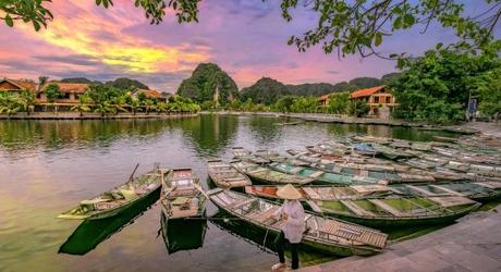 Enchanting Travels Vietnam Tours Hoi An Rowing boat Waiting for passengers at sunrise,