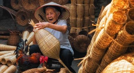 Enchanting TraOld Vietnamese female craftsman making the traditional bamboo fish trap