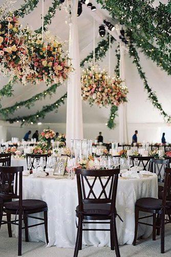 spring wedding decor reception under white tent with greenery and bright hanging flowers tecpetaja
