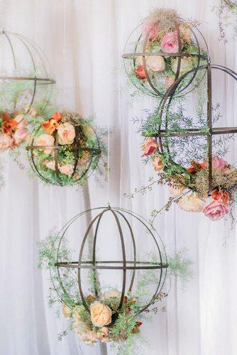 spring wedding decor hanging cages with pink peach roses and greenery manda weaver photography