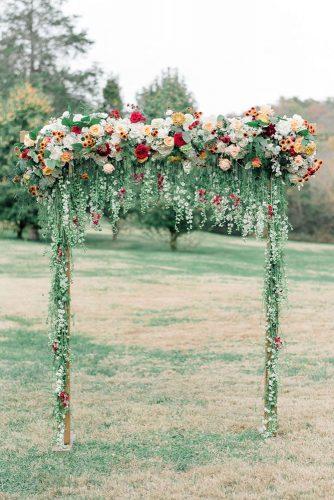 spring wedding decor garden ceremony arch with greenery and hanging flowers julie paisley associates