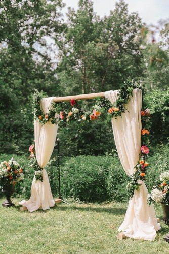 spring wedding decor garden ceremony arch with cream cloth and greenery flower garland oak & myrrh photography