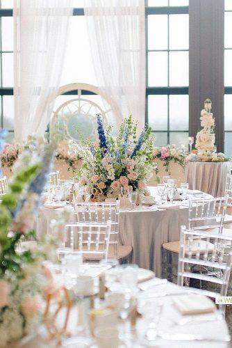 spring wedding décor reception with white tablecloth and flower centerpieces beigeweddings