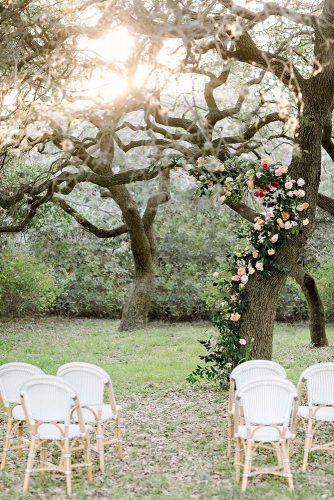spring wedding decor garden ceremony altar with real tree backdrop with flowers and greenery julie wilhite