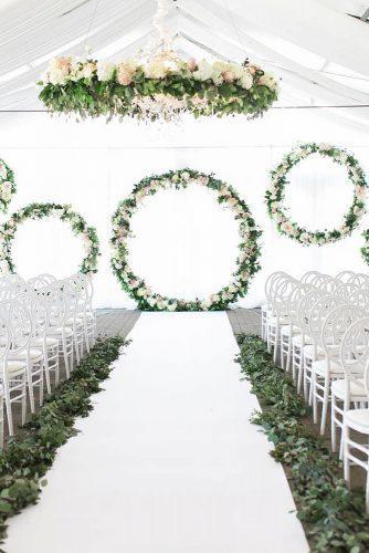 spring wedding décor under white tent woth greenery aisle round shapes arch with roses laurenkurc