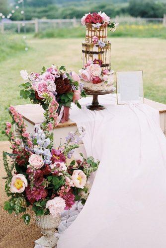 spring wedding decor vintage stand with bright flowers and drip cake baxterandted