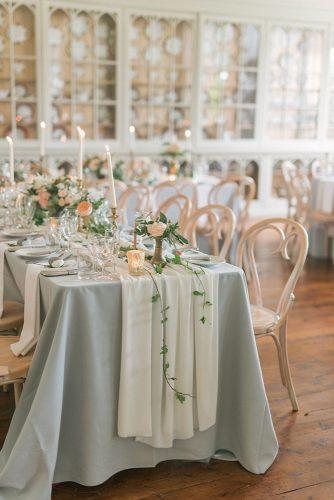 silver sage wedding reception tablecloth with greenery candles and roses emma pilkington photography