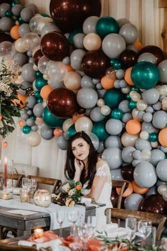 silver sage wedding reception with balloons on wall moody tones wild native co