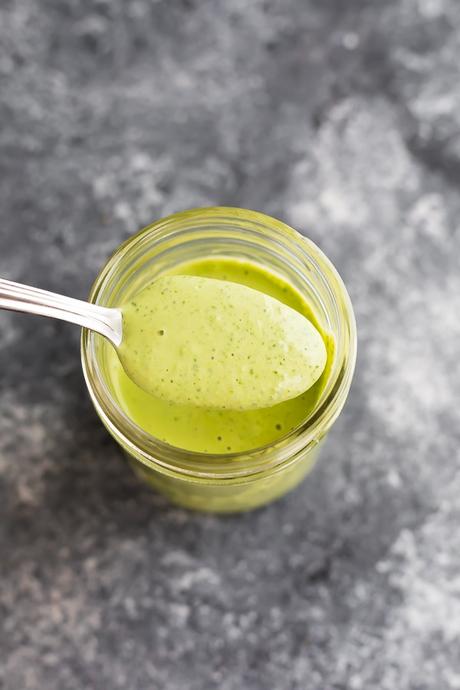 overhead view of green goddess dressing on a spoon