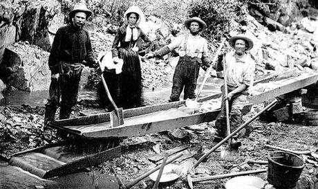 Image: 1850 Woman and Men in California Gold Rush | A woman with three men panning for gold during the California Gold Rush