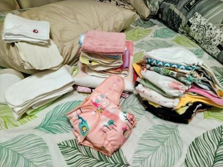 Pile of Cloth Diapers and Baby Stuff
