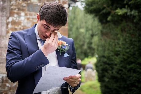 Crying groom reading letter
