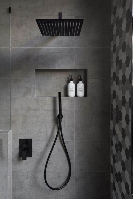 walk in showers matte black finish shower head matte black fixtures gray tile geometric patterns