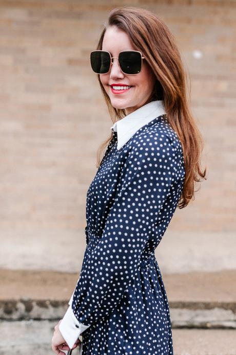 Amy Havins wears a navy polka dot dress
