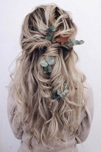 bohemian wedding hairstyles volume long blonde curls half up half down with braid and eucalyptus leaves makeupditt