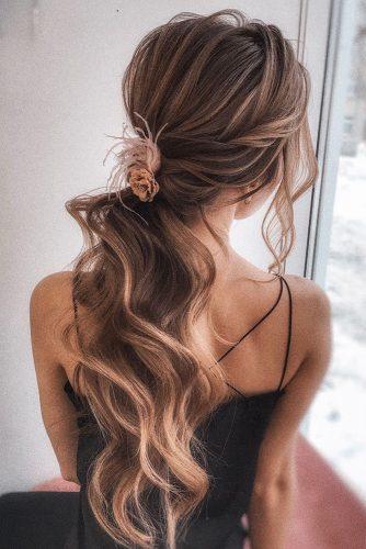 bohemian wedding hairstyles elegant long curly swept ponytail with pink flower pin olesya_zemskova_