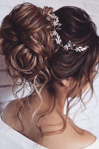 bohemian wedding hairstyles volume high bun with loose brown curls and accessorie silver hairspray_studio