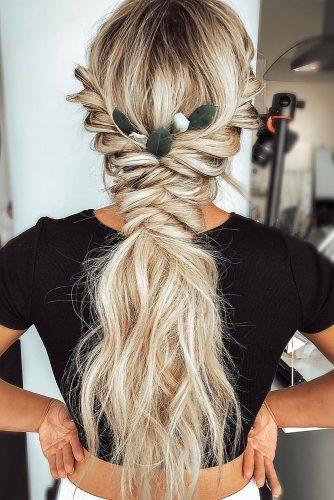 bohemian wedding hairstyles long blonde hair braided texture and green leaves in hair blohaute