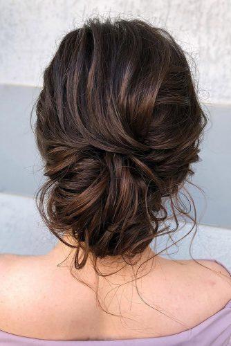 bohemian wedding hairstyles elegant and messy low bun on medium brown hair veronika_belyanko