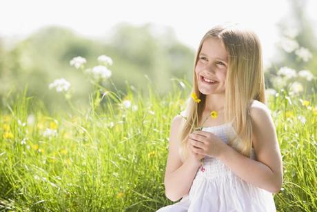 Young girl sitting outdoors enjoying the clean environment