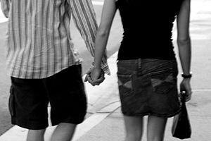 A male and a female holding hands.