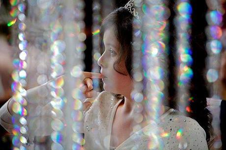 young girl at a wedding with sparkles