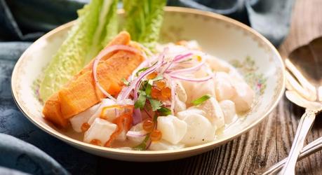 Peruvian ceviche with halibut and roe plated in a classic dish on rustic wood