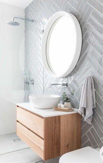 basic single vessel sink floating vanity with wood finish against chevron style gray tiles