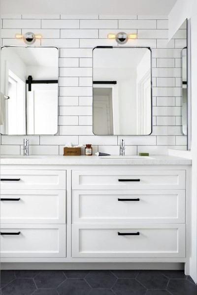 all white bathroom with subway tile backsplash and matte black accent features