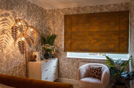 Glamorous bedroom inspo - blush pink armchair and all accessories by Audenza, patterned gold wallpaper by Harlequin, mustard roman blind by Harlequin.