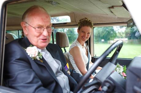 a bride arrives in the wedding landrover