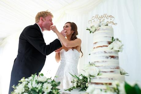 bride and groom share the wedding cake