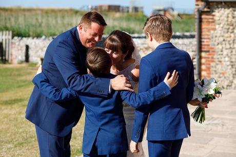 a family hug at a cley mill wedding