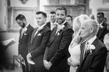 a groom glance at his bride as she arrives in church