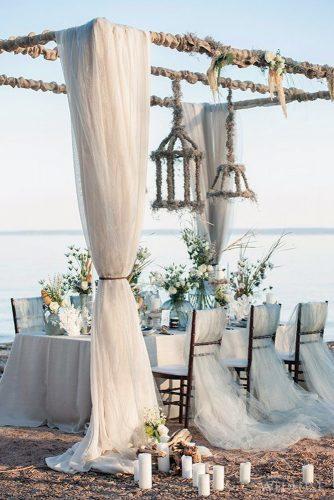 nautical wedding outdoor table decor ideas with flowers white cloth candles and hanging lamps krista fox