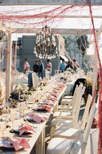 nautical wedding outdoor table decor with net and rope and flowers ashley kelemen