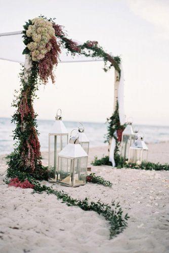 nautical wedding arch with cloth flowers and seaweed with lanterns ozzy garcia photography
