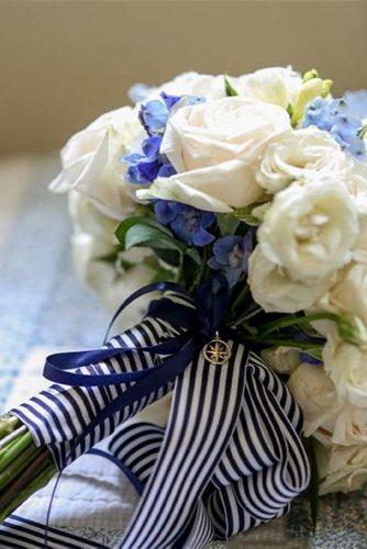 nautical wedding bouquet with white and blue flowers with stripes ribbons and suspension compass rodeoandco