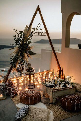 bohemian wedding decorations triangle arch with pampas grass and signs candles chris & ruth